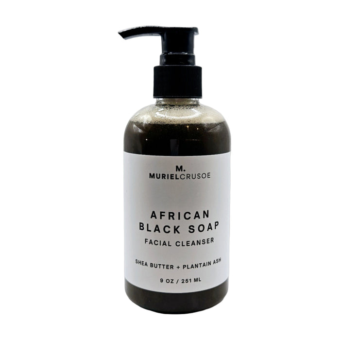 A pump bottle of African Black Soap facial cleanser with a white label that includes the product name and a note about shea butter and plantain leaf extract.