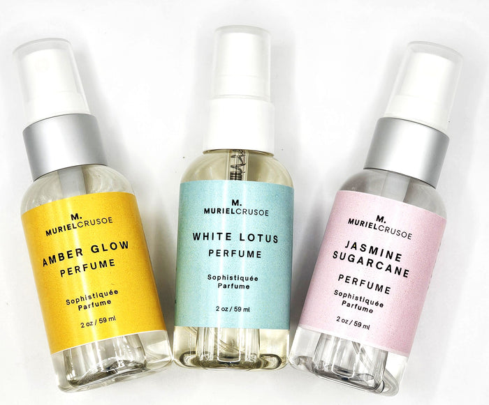 Three perfume bottles with different colored labels on a white background