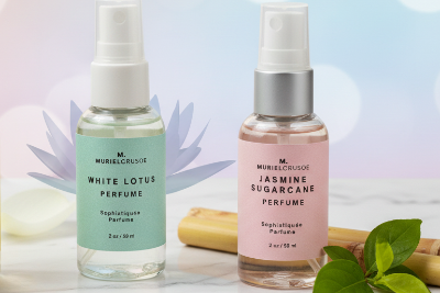 Two perfume bottles labeled 'White Lotus' and 'Jasmine Sugarcane' with a blurred natural background.