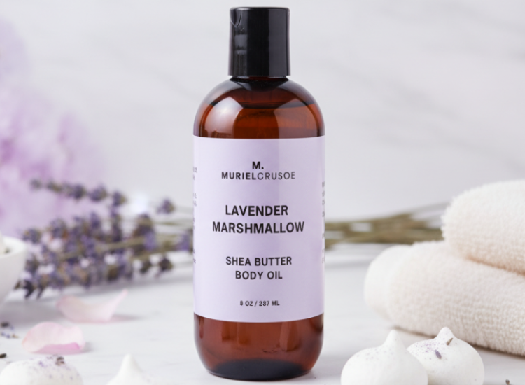 Shea butter body oil bottle with lavender marshmallow scent on a neutral background